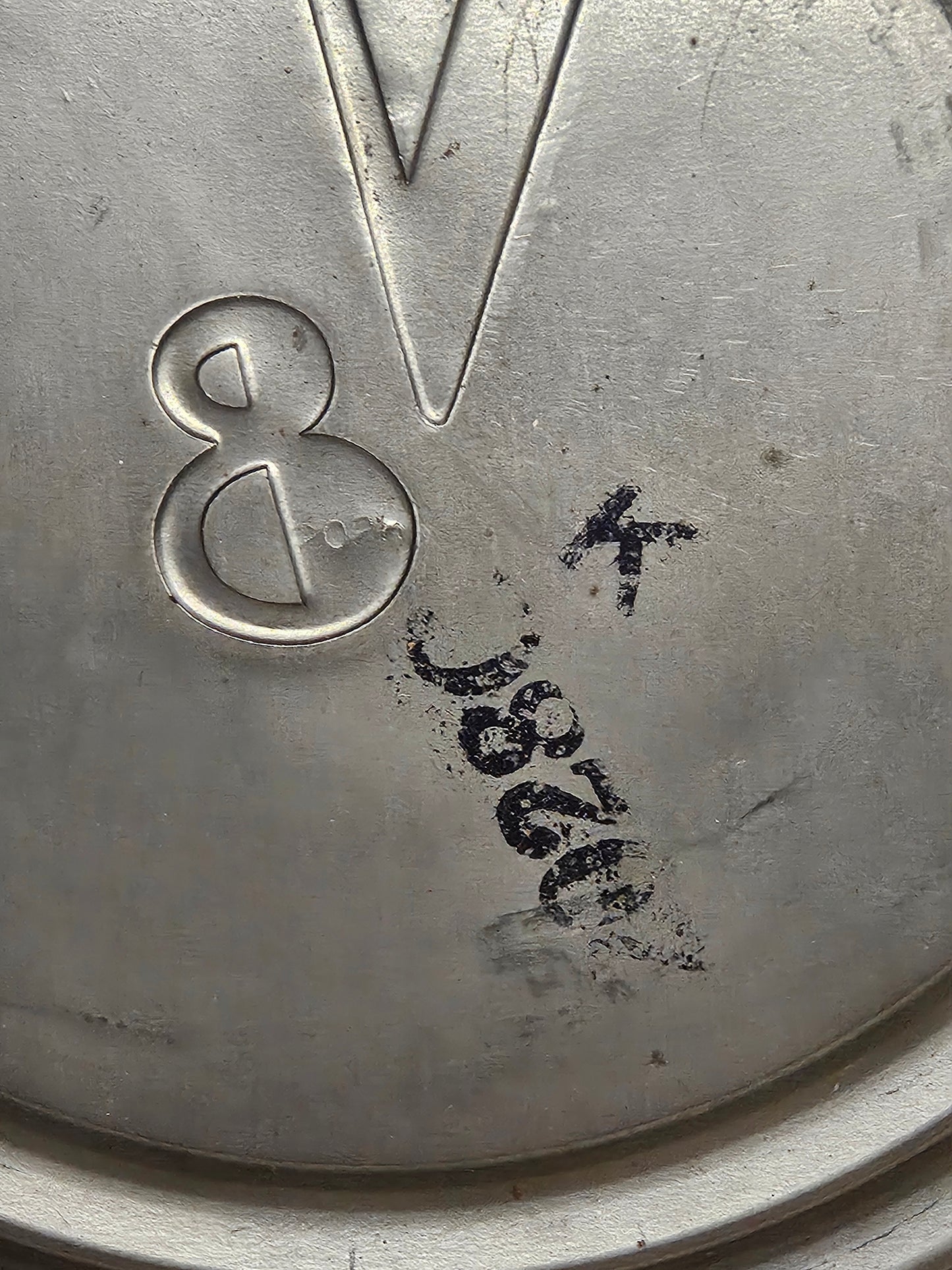 Second hubcap interior showing 2028C stamp and V8 emblem