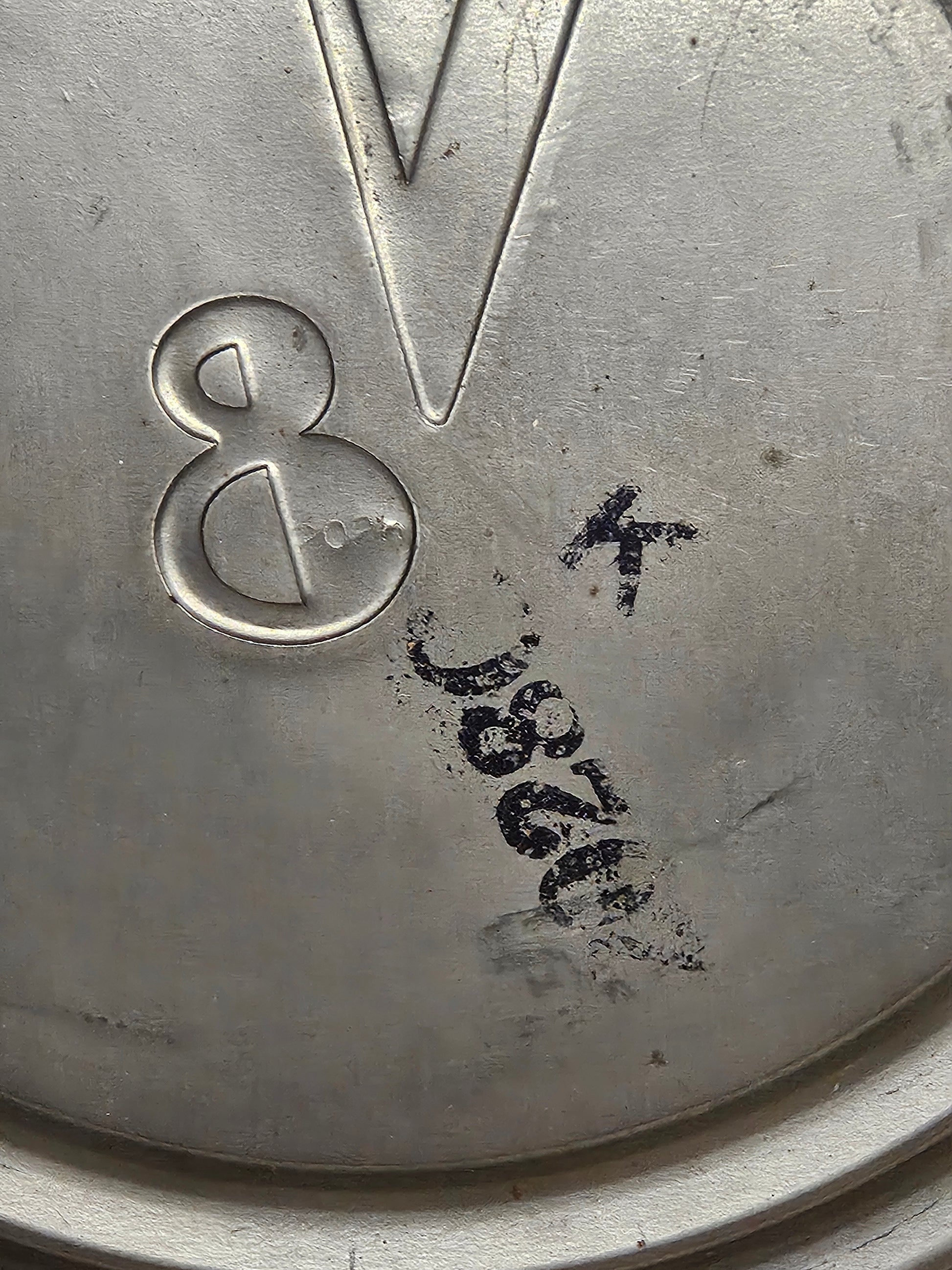 Second hubcap interior showing 2028C stamp and V8 emblem