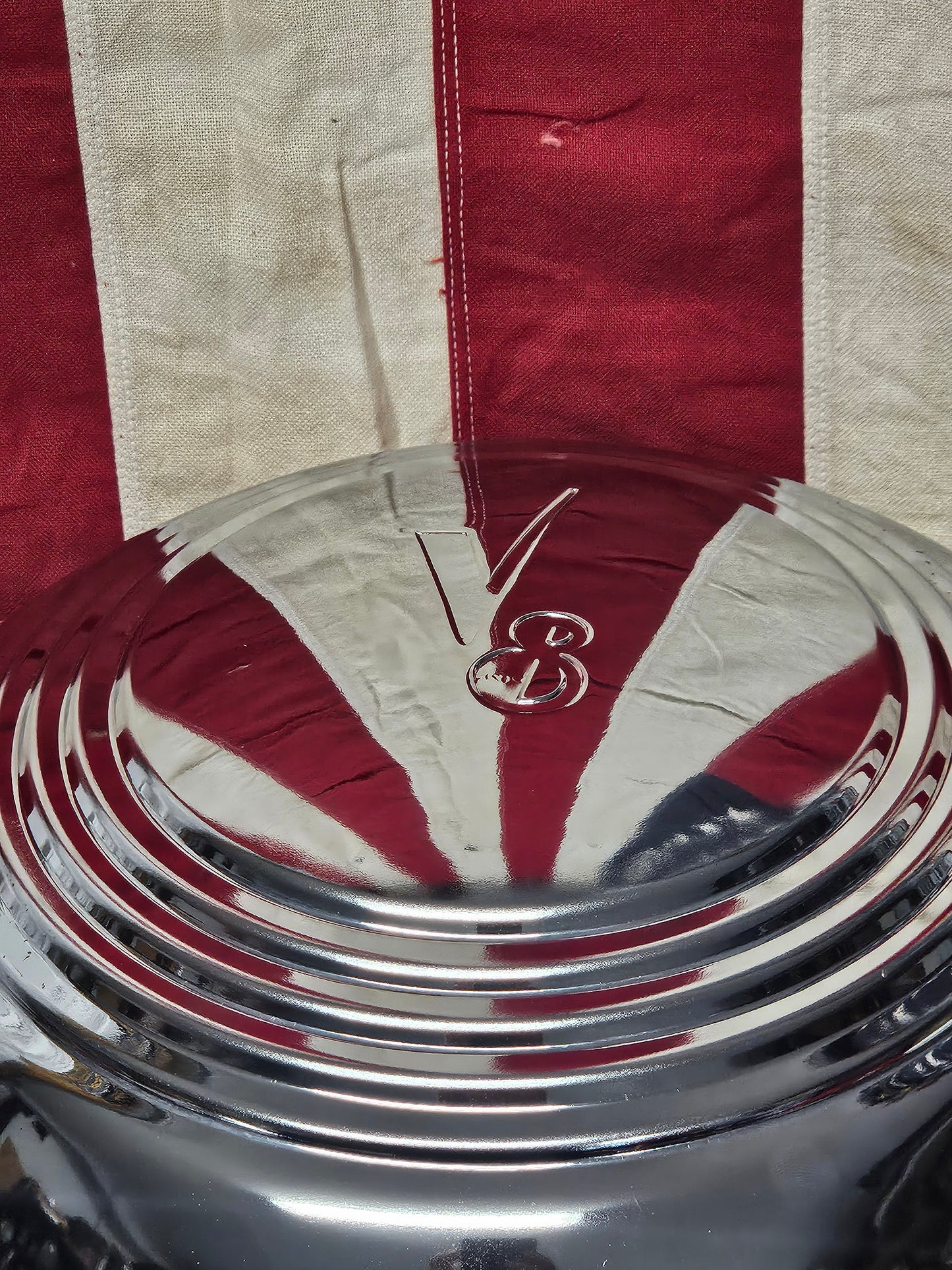 Ford V8 wide five hubcap face showing concentric ring profile and bright chrome