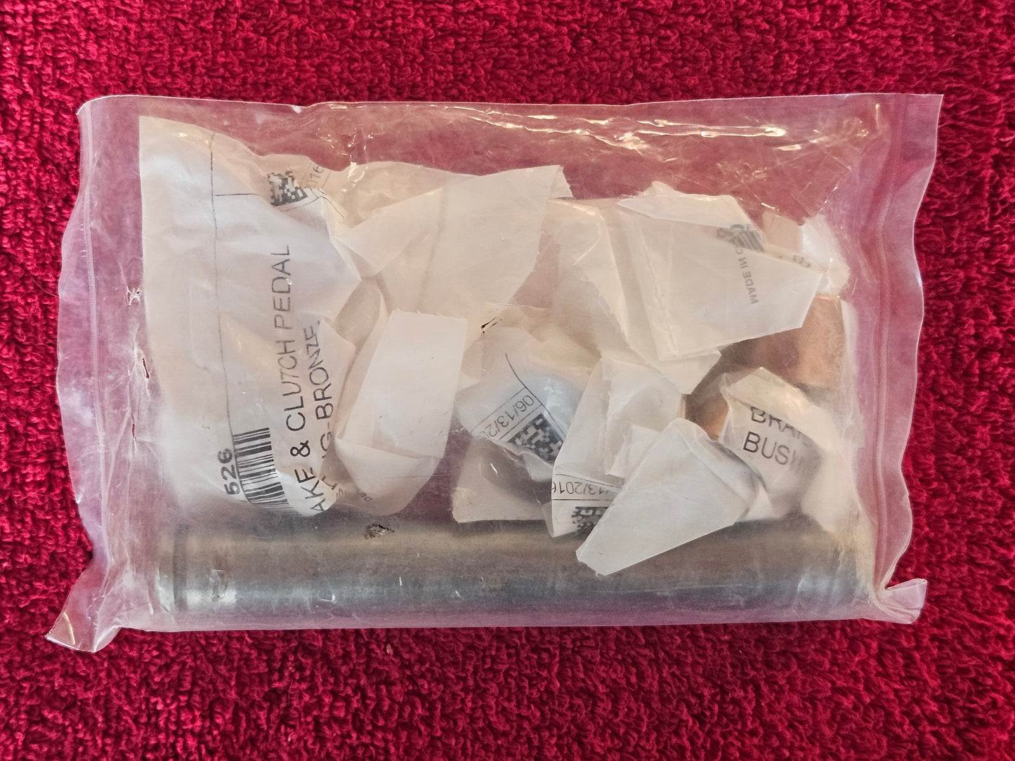 Inner labels showing brake and clutch pedal bronze bushings inside the sealed bag