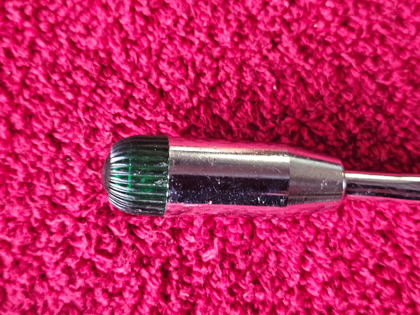 Close view of chromed lever end and green indicator jewel