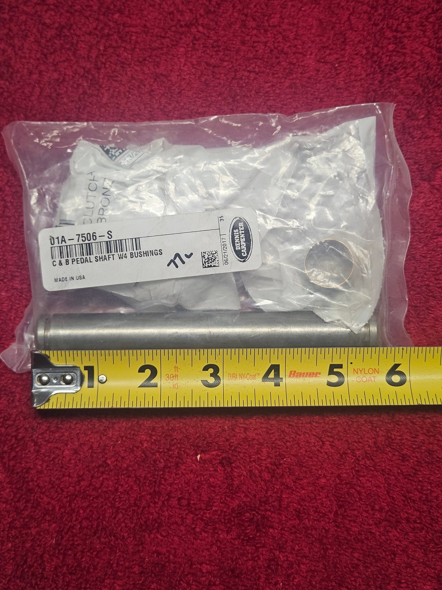 Dennis Carpenter 01A-7506-S clutch and brake pedal shaft set shown against a tape measure, approximately 5-1/2 inches