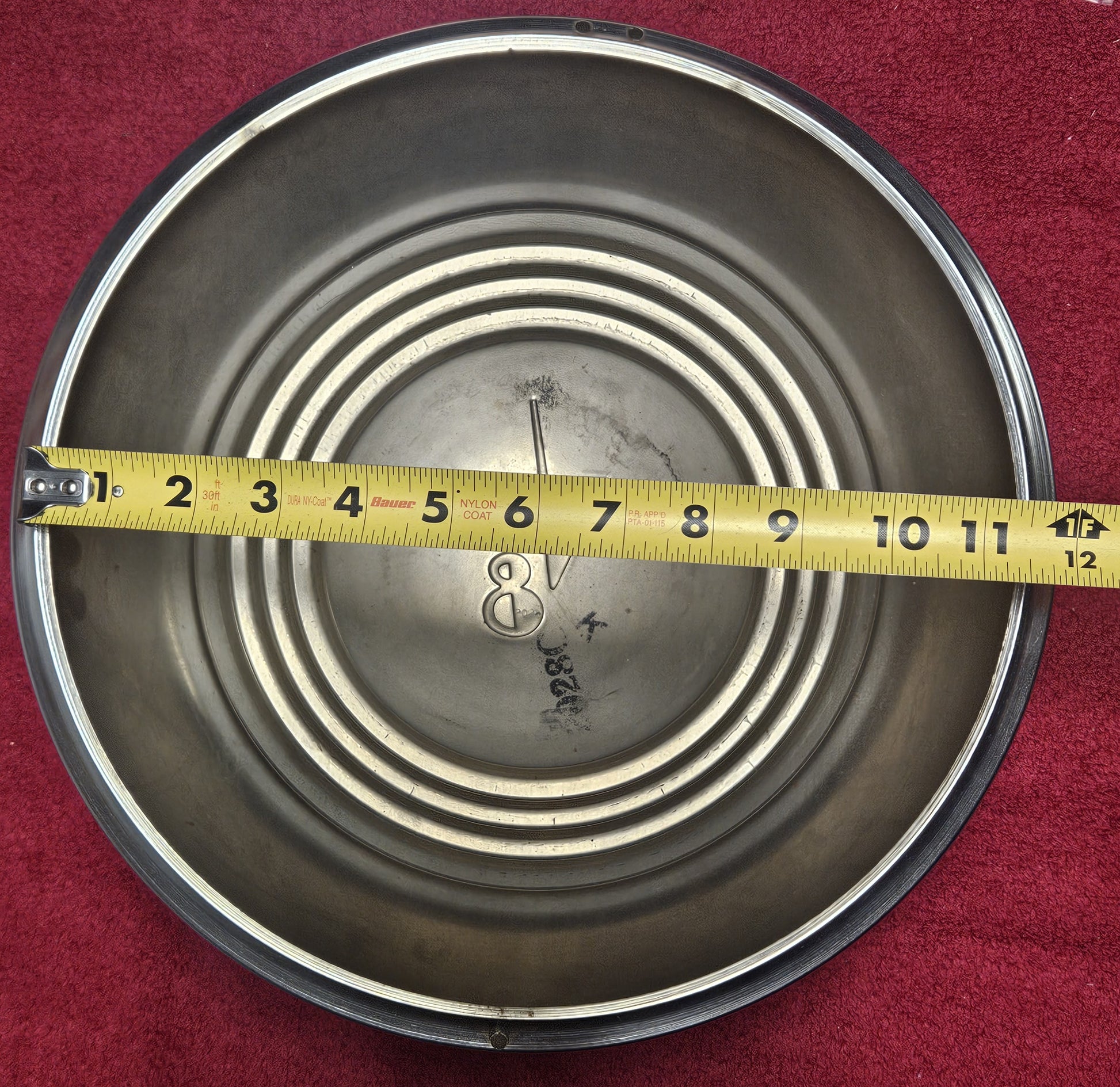 Wide five hubcap measured against a tape, approximately 11-1/2 inches lip to lip