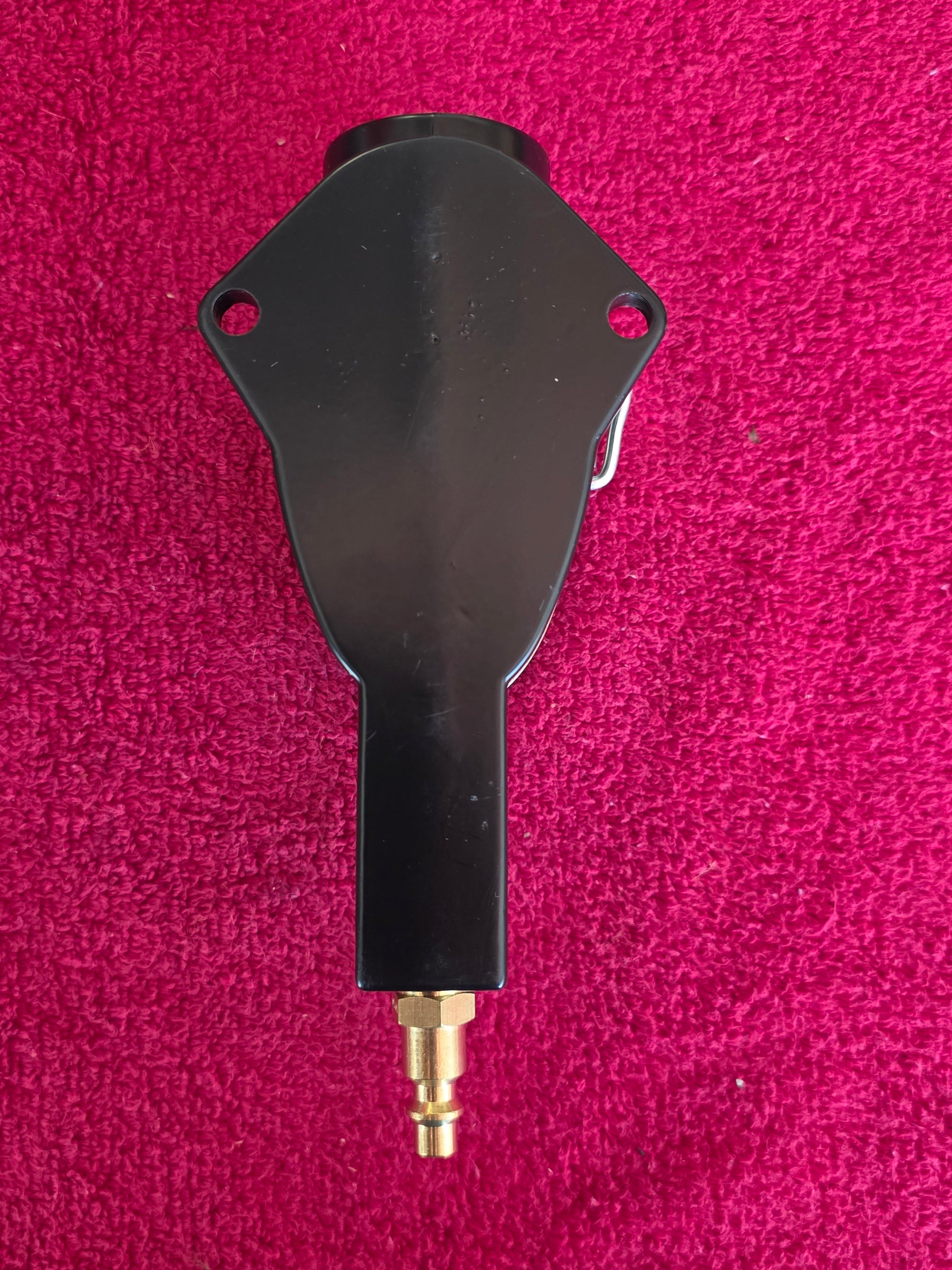 Back of the spark plug cleaner showing the wall mounting flange and inlet