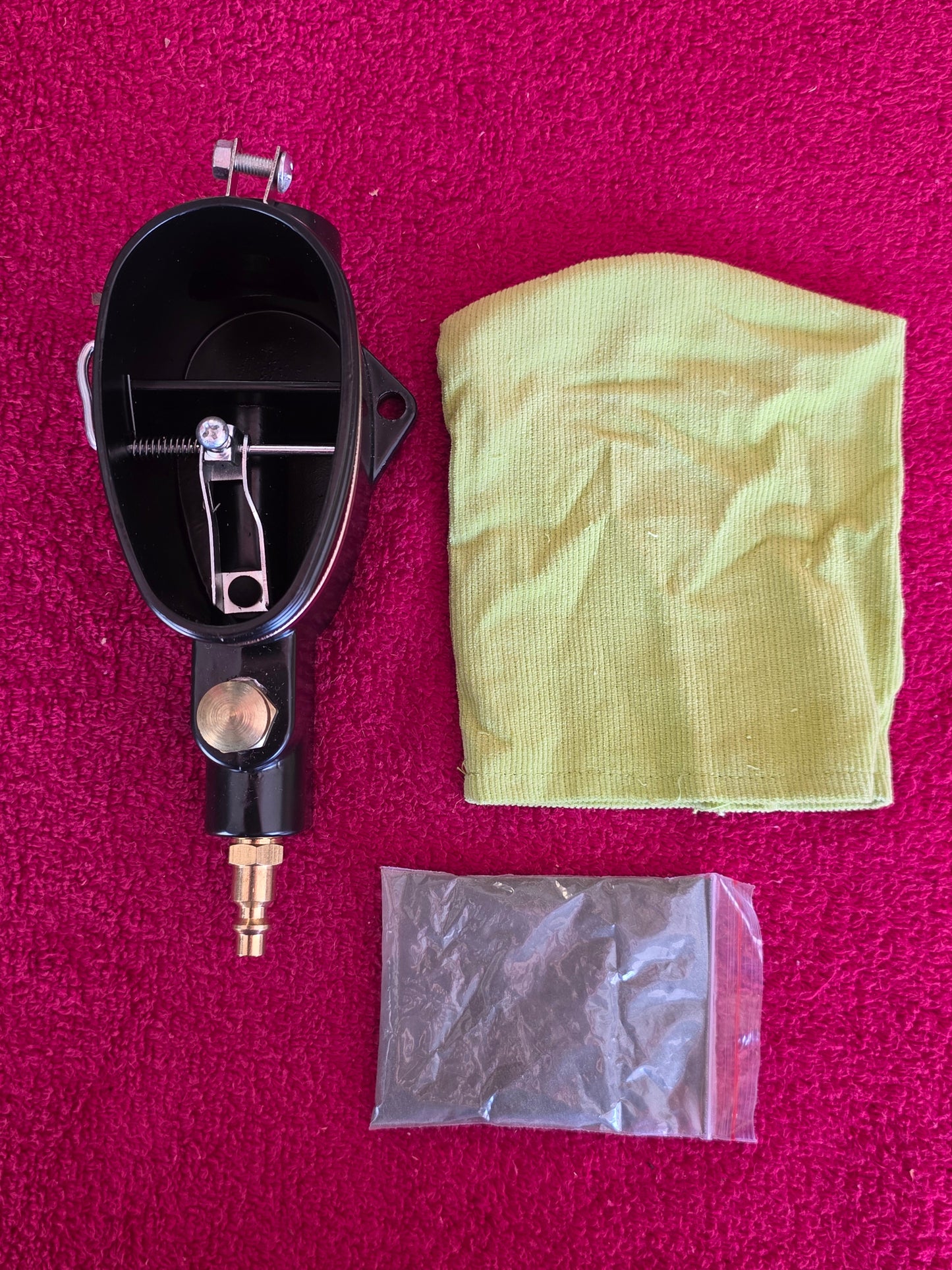 Abrasive spark plug cleaner with its cloth collection bag and sealed bag of abrasive media