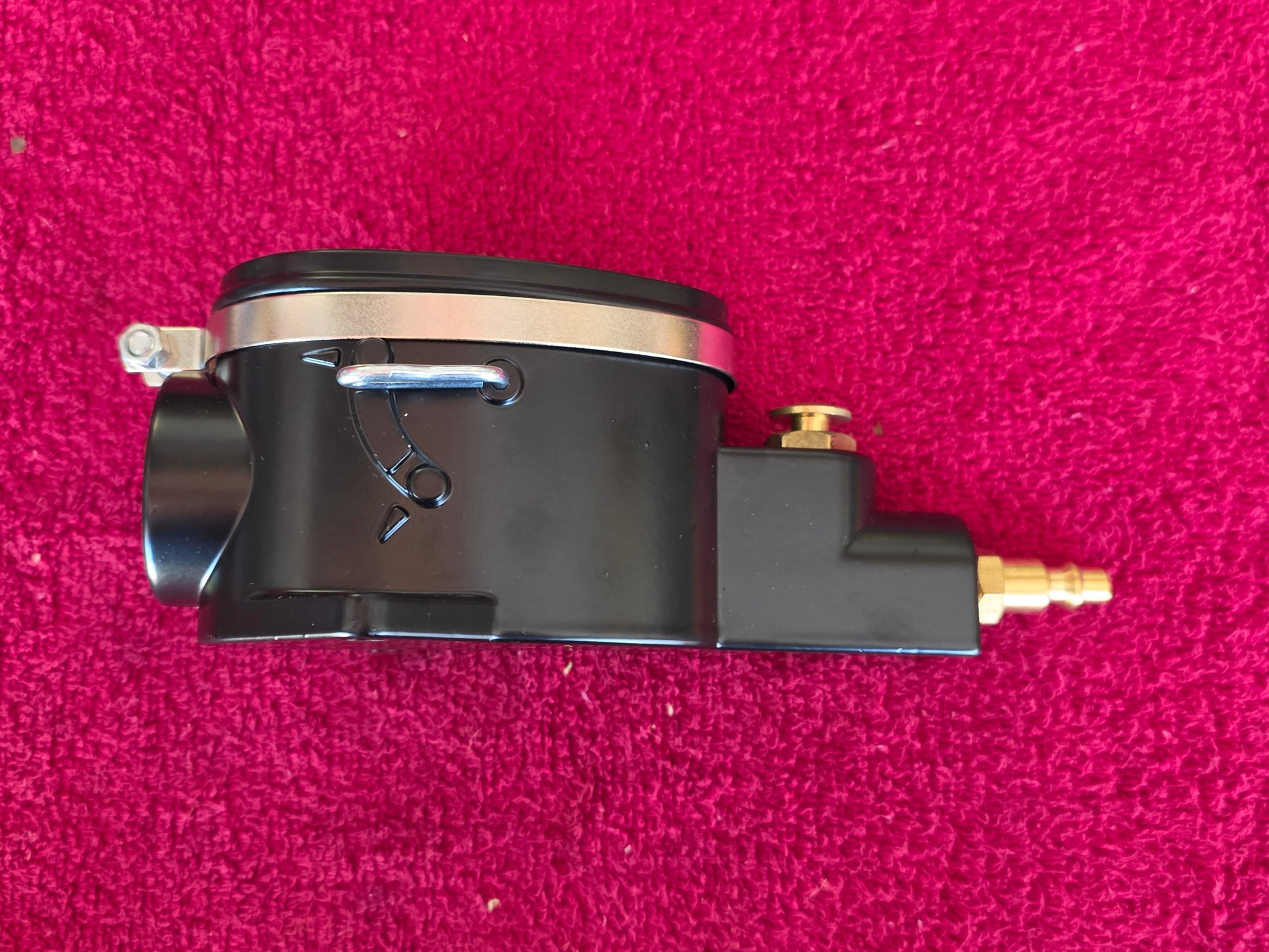 Side of the spark plug cleaner showing the air and blast selector positions and the chrome clamp band