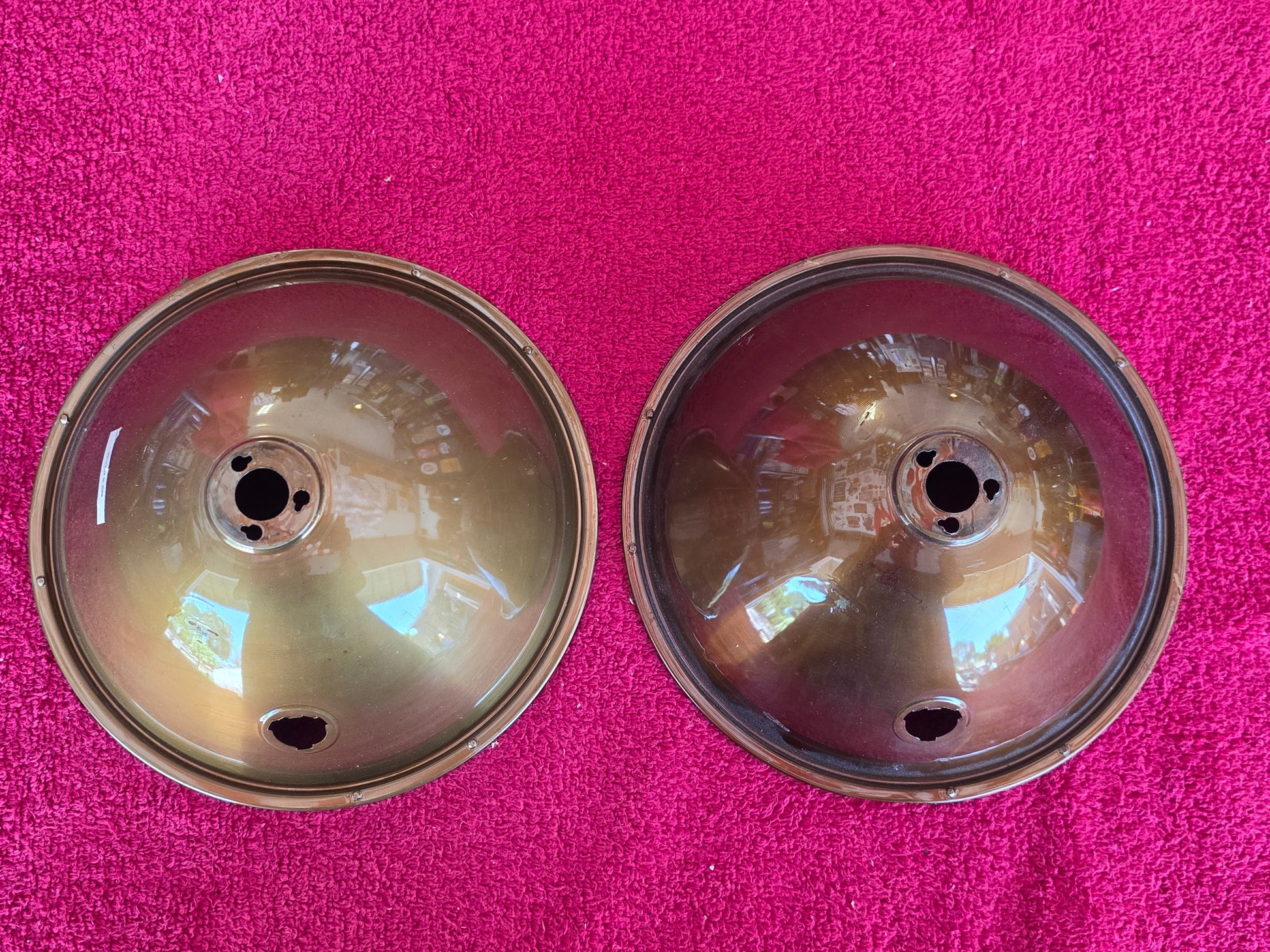 Reverse of both headlight reflectors showing the rolled rim and centre hub