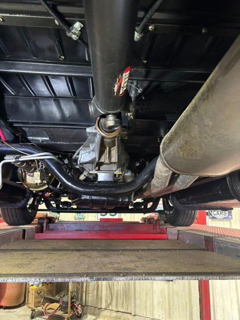 Underside on a lift - painted floor pan, driveshaft, transmission tailshaft and dual exhaust