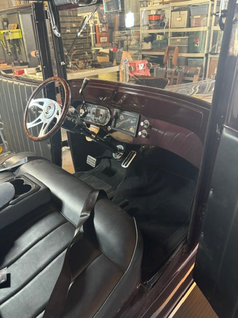 Dash painted body color in Sangria maroon - wood-rim wheel on polished three-spoke center, Dakota Digital gauges, center-dash head unit and Vintage Air knobs, black carpet