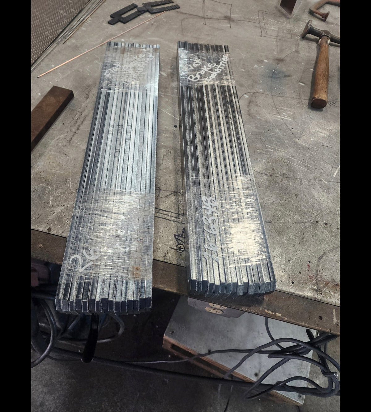 Stacks of water-jet cut bracket blanks